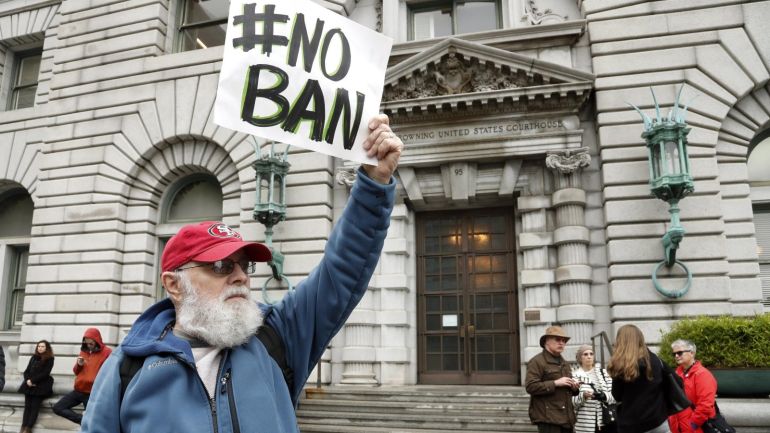 88bd9acf-394d-4700-959c-6d982c21b48b epaselect epa05777383 An anti-travel ban protestor with a poster reading 'NO BAN' stands outside the Ninth US Circuit Court of Appeals as three-judge federal appeals panel from the court scheduled a hearing by telephone with lawyers of the US Department of Justice (DOJ) and the State of Washington to determine whether to reinstate US President Donald Trump's executive order ban on travel to the United States from seven Muslim-majority countries in San Francisco, Cali