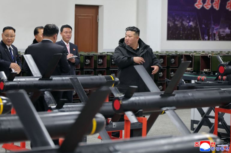 This picture taken on January 3, 2026 and released by North Korea's official Korean Central News Agency (KCNA) via KNS on January 4, 2026 shows North Korean leader Kim Jong Un visiting a factory involved in making tactical guided weapons, at an undisclosed place in North Korea. (Photo by KCNA VIA KNS / AFP) / SOUTH KOREA OUT / ---EDITORS NOTE--- RESTRICTED TO EDITORIAL USE - MANDATORY CREDIT "AFP PHOTO/KCNA VIA KNS" - NO MARKETING NO ADVERTISING CAMPAIGNS - DISTRIBUTED AS A SERVICE TO CLIENTS THIS PICTURE WAS MADE AVAILABLE BY A THIRD PARTY. AFP CAN NOT INDEPENDENTLY VERIFY THE AUTHENTICITY, LOCATION, DATE AND CONTENT OF THIS IMAGE.