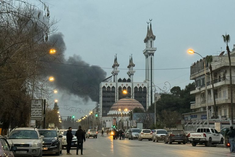 afp_6960a13c529b-1767940412 Columns of smoke rise from the site of artillery shelling that targeted the area near Aleppo’s Abdelrahman Mosque on January 8, 2026, amid intense clashes between government forces and the Kurdish Syrian Democratic Forces (SDF) forces.