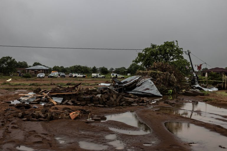 Search and rescue teams' vehicles are parked next to a damaged structure following floods in Mbaula village, 50 km from Giyani on January 17, 2026 following heavy rains over much of the Limpopo Province, South Africa.