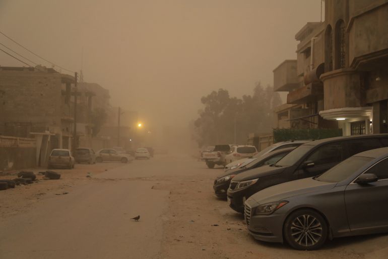 Vehicles are parked as poor visibility from strong winds and a storm engulfs the eastern coastal city of Benghazi on January 20, 2026. (Photo by Abdullah DOMA / AFP)