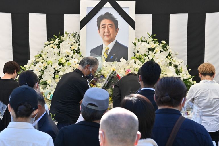 (FILES) This photo taken on September 27, 2022 shows people offering their respects to former Japanese prime minister Shinzo Abe outside the Nippon Budokan in Tokyo, ahead of his state funeral later in the day.