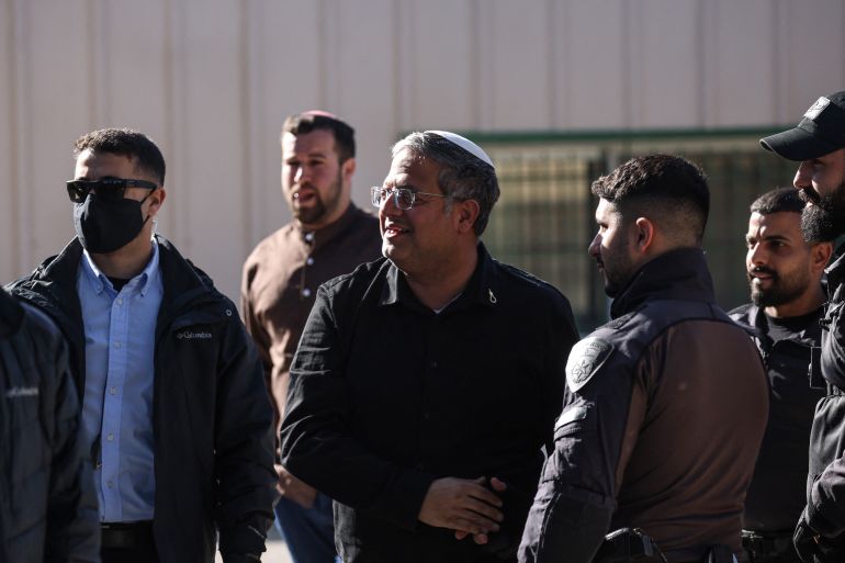 Far-right National Security Minister Itamar Ben Gvir greets security forces as demolition work takes place inside the headquarters of the United Nations Relief and Works Agency (UNRWA) in the Sheikh Jarrah neighbourhood of Israeli-annexed east Jerusalem on January 20, 2026.