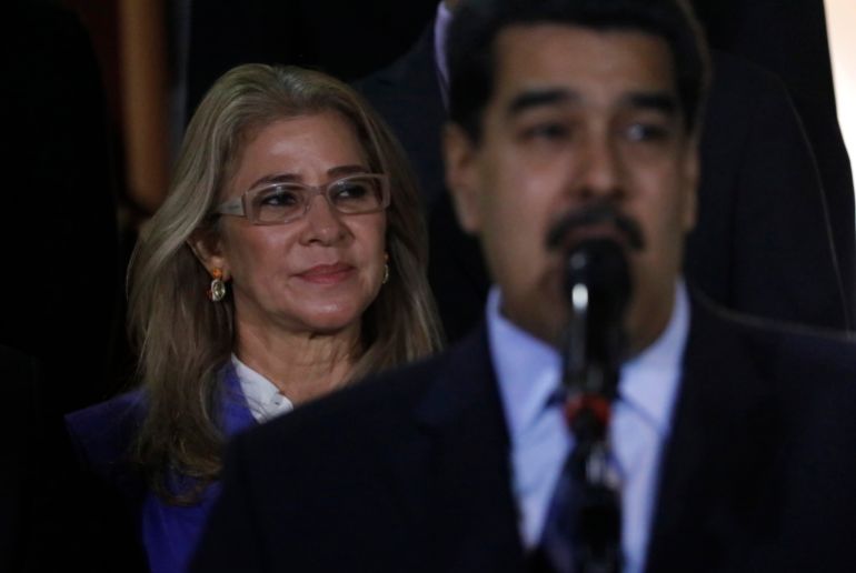 FILE - First lady Cilia Flores stands behind her husband Venezuela's President Nicolas Maduro during a press conference, at the Miraflores Presidential Palace, in Caracas, Venezuela, June 21, 2019. (AP Photo/Ariana Cubillos, File)