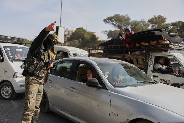 ap_695e90ae22821-1767805102-1 A Syrian government soldier directs residents who are fleeing from Sheikh Maqsoud and Achrafieh neighborhoods after clashes broke out on Tuesday between Syrian government forces and Kurdish fighters in a contested area of the northern city of Aleppo, Syria, Wednesday, Jan. 7, 2026. (AP Photo/Omar Albam)