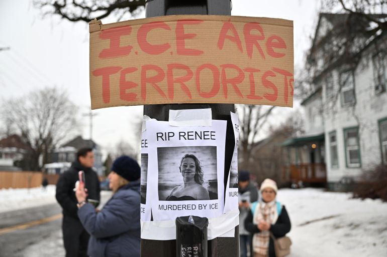 People gather around a makeshift memorial honoring the victim of a fatal shooting involving federal law enforcement agents, near the site of the shooting, Thursday, Jan. 8, 2026, in Minneapolis. (AP Photo/Tom Baker)