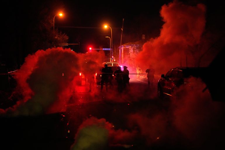 ap_69690716a3b6b-1768490774 Tear gas surrounds federal law enforcement officers as they leave a scene after a shooting on Wednesday, Jan. 14, 2026, in Minneapolis. (AP Photo/John Locher)