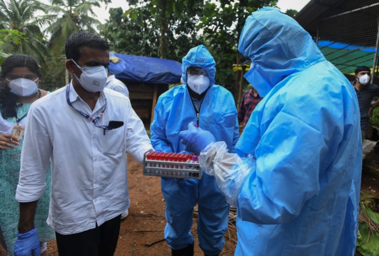 Health workers collect blood samples from goats in the neighborhood for testing after a 12-year-old boy died of the Nipah virus in Kozhikode, Kerala state, India, Tuesday, Sept.7, 2021. The southern Indian state is quickly ramping up efforts to stop a potential outbreak of the deadly Nipah virus, even as it continues to battle the highest number of coronavirus cases in the country. (AP Photo/Shijith. K)