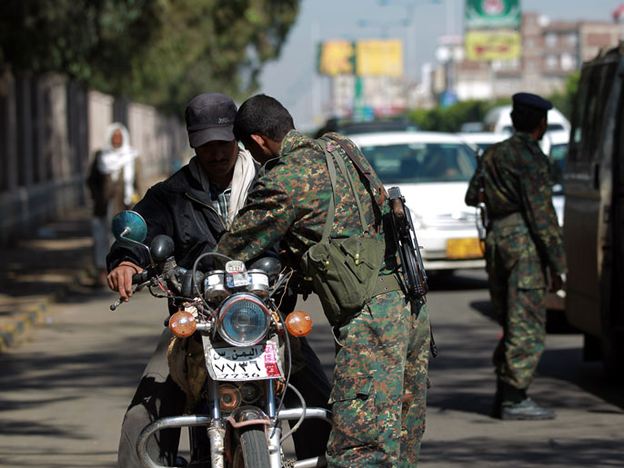d3a301ad-5c20-419f-8dc1-f937769cba35 HUW003 - Sanaa, -, YEMEN : Yemeni soldiers man a checkpoint in the capital Sanaa on November 23, 2013, next to the area where MP Abdel Karim Jadban was shot the day before. Jadban, who represented Zaidi Shiite rebels known as Huthis at a national dialogue was assassinated on November 22, in the Yemeni capital, an official from his group told AFP. AFP PHOTO/ MOHAMMED HUWAIS