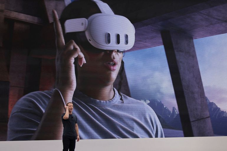 Meta CEO Mark Zuckerberg delivers a speech, as a person wearing a VR headset appears on screen, during the Meta Connect event at the company's headquarters in Menlo Park, California, U.S., September 27, 2023. REUTERS/Carlos Barria