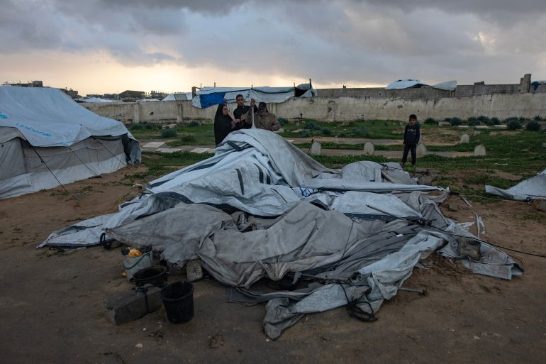 epa_6963aac94b9b-1768139465 epa12639020 A Palestinian family is trying to gather what remains of their belongings after their tent was damaged in Khan Younis in the southern Gaza Strip, 09 January 2026. The tent sheltering the Palestinian family was destroyed by strong winds and heavy rain, leaving the family without shelter. EPA/HAITHAM IMAD