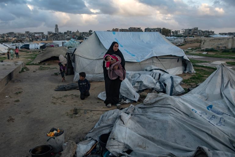epa12639028 A Palestinian family is trying to gather what remains of their belongings after their tent was damaged in Khan Younis in the southern Gaza Strip, 09 January 2026. The tent sheltering the Palestinian family was destroyed by strong winds and heavy rain, leaving the family without shelter. EPA/HAITHAM IMAD