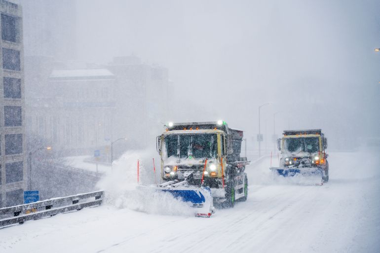 epa12681071 Plow trucks clear the road during a winter storm in the Brooklyn borough of New York, New York, USA, 25 January 2026. The city is under a winter storm warning with forecasters predicting 10-14 inches of snow on 25 January. EPA/OLGA FEDOROVA