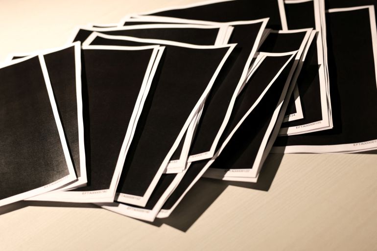 Newly-released documents from disgraced late financier and sex offender Jeffrey Epstein, including a sheaf of entirely redacted pages, are seen in this handouts released by the U.S. Justice Department and printed and arranged for a photograph by Reuters in Washington, D.C., U.S., December 19, 2025. REUTERS/Jonathan Ernst