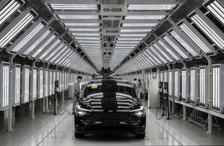 HEFEI, CHINA - JANUARY 17: A worker from Chinese electric vehicle (EV) company NIO checks the charging system during the final inspection of a car at the end of the automated production line at the companys manufacturing hub on January 17, 2025 in Hefei, China. China produces and exports more electric vehicles than any other country, leading the global electric vehicle (EV) market with production capacity that now outpaces domestic sales. Luxury brand NIO saw a 38% rise in EV deliveries in 2024 and is looking to further its expansion into overseas markets with a range of premium vehicles, a new lower priced sub-brand, and its battery swapping charging system. Exports of Chinese EVs exceeded two million for the first time in 2024, according to government figures. While the global expansion of Chinas EV industry has triggered trade tensions with the U.S. and Europe where governments are enacting tariffs on China-made electric cars, the companies are making inroads in markets in Asia, South America, and Africa. Chinese brands have become known worldwide for design and advanced EV technology at competitive prices, as they continue to fuel a transition to electric vehicles at home in the worlds largest car market. (Photo by Kevin Frayer/Getty Images)