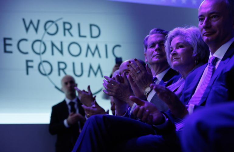 getty_69732e2dbc-1769156141 DAVOS, SWITZERLAND - JANUARY 22: (L-R) U.S. Treasury Secretary Secretary Scott Bessent, White House Chief of Staff Susie Wiles and Bulgarian politician and diplomat Nikolay Mladenov applaud during a presentation by Trump Administration officials about post-war Gaza following a signing ceremony for the “Board of Peace” at the World Economic Forum (WEF) on January 22, 2026 in Davos, Switzerland. The US-backed “Board of Peace” is intended to administer the fragile ceasefire in the Gaza Strip after the war between Israel and Hamas. The final makeup of the board has not been confirmed. (Photo by Chip Somodevilla/Getty Images)