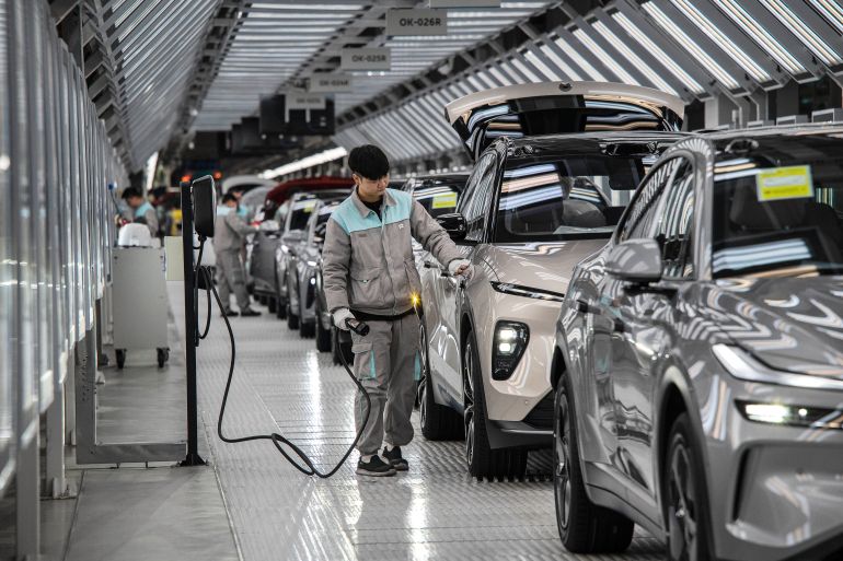 getty_69737d9cda-1769176476 HEFEI, CHINA - JANUARY 17: A worker from Chinese electric vehicle (EV) company NIO inspects a vehicles charging system in the final quality control area on the automated production line at the companys manufacturing hub on January 17, 2025 in Hefei, China. China produces and exports more electric vehicles than any other country, leading the global electric vehicle (EV) market with production capacity that now outpaces domestic sales. Luxury brand NIO saw a 38% rise in EV deliveries in 2024 and is looking to further its expansion into overseas markets with a range of premium vehicles, a new lower priced sub-brand, and its battery swapping charging system. Exports of Chinese EVs exceeded two million for the first time in 2024, according to government figures. While the global expansion of Chinas EV industry has triggered trade tensions with the U.S. and Europe where governments are enacting tariffs on China-made electric cars, the companies are making inroads in markets in Asia, South America, and Africa. Chinese brands have become known worldwide for design and advanced EV technology at competitive prices, as they continue to fuel a transition to electric vehicles at home in the worlds largest car market. (Photo by Kevin Frayer/Getty Images)