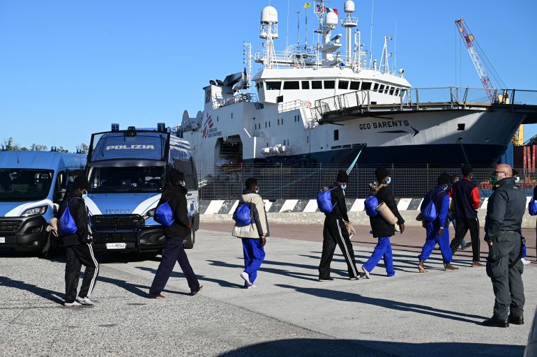 getty_697ba9cec6-1769712078 AUGUSTA, ITALY - DECEMBER 30: A group of male migrants, after disembarking from the ship Geo Barrentes of Médecins Sans Frontières (in the background), are in line to embark on the (quarantine) ship "Allegra" of the NGV company, in the port of Augusta on December 30, 2021 in Augusta, Italy. Some 558 persons were disembarked over two days from the Geo Barents, the ship of Doctors Without Borders (MSF). The migrants were rescued in eight rescue operations that took place from 17 to 24 December in the central Mediterranean Sea. The migrants, who were transferred to a quarantine ship, tested negative for swabs. Almost all of them came from North Africa and sub-Saharan Africa. Among them was a pregnant woman in her eighth month of pregnancy and 174 minors, 143 of whom were unaccompanied, transferred to the Caltanissetta reception centre. (Photo by Fabrizio Villa/Getty Images)