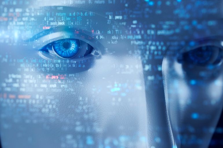 Close-up of a robot staring at code.