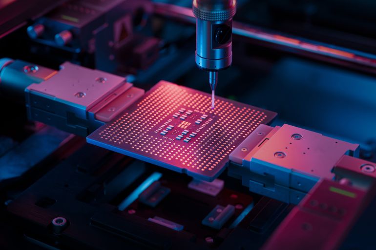 Advanced Microchip illuminated with Red Light in Industrial Environment. Computer Chip on Conveyor Line during Production and Packaging Process on Semiconductor Fab.; Shutterstock ID 2550405885; purchase_order: d; job: ; client: ; other: