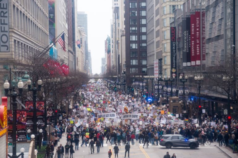 CHICAGO, ILLINOIS, UNITED STATES - APRIL 5: Thousands gather in Chicago's streets to protest President Donald Trump and Elon Musk's policies, joining over 1,400 rallies across the US on April 5, 2025. The 'Hands Off!' movement is a response to Trump and Musk's policies, which many see as an attack on American values and freedoms. Protesters demand an end to the slashing of jobs, invasion of privacy, and assault on services, calling for a return to democratic values. (Photo by Jacek Boczarski/Anadolu via Getty Images)