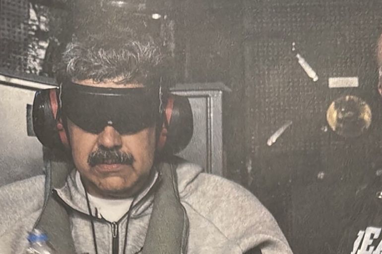 maduroo745-1767459614-1 A photograph which U.S. President Donald Trump posted on his Truth Social account shows what he describes as Venezuelan President "Nicolas Maduro on board the USS Iwo Jima" amphibious assault ship, currently in the Caribbean Sea January 3, 2026. The image appears to be taken from a printed photograph, as white edging can be seen around the image. What appears to be the letters DEA can be seen on a black uniformed person next to Venezuelan president Maduro. U.S. president Trump said DEA officials were involved in the operation. Verifying the location was not immediately possible as the photograph is tightly cropped. But the patterning of grey hairs within Maduro's mustache matched recent imagery of him. @realDonaldTrump/Handout via REUTERS THIS IMAGE HAS BEEN SUPPLIED BY A THIRD PARTY. THIS PICTURE WAS PROCESSED BY REUTERS TO ENHANCE QUALITY. AN UNPROCESSED VERSION HAS BEEN PROVIDED SEPARATELY.