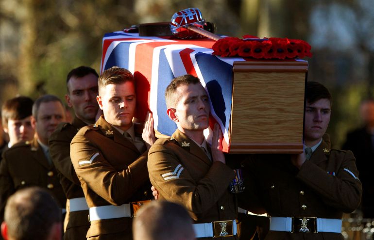 FILE PHOTO: Soldiers from the Royal Regiment of Scotland carry the coffin of Captain Walter Barrie after his funeral service at Glencorse Kirk near Edinburgh, Scotland November 29, 2012. Captain Barrie, of The Royal Scots Borderers, 1st Battalion The Royal Regiment of Scotland (1 Scots), was playing in a soccer match between British soldiers and members of the Afghan National Army (ANA) on Remembrance Day at their base in Helmand province in Afghanistan, when he was shot by a rogue member of the Afghan army, according to local media. REUTERS/David Moir/File Photo