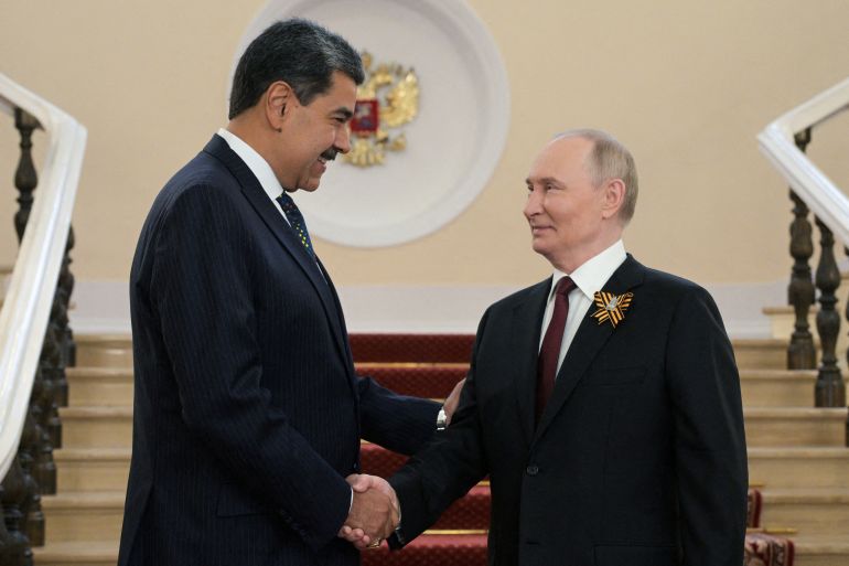 FILE PHOTO: Russia's President Vladimir Putin greets Venezuela's Nicolas Maduro before a military parade atteneded by foreign leaders on Victory Day, marking the 80th anniversary of the victory over Nazi Germany in World War Two, in Moscow, Russia, May 9, 2025. Alexei Nikolsky/Host agency RIA Novosti/Handout via REUTERS ATTENTION EDITORS - THIS IMAGE WAS PROVIDED BY A THIRD PARTY./File Photo