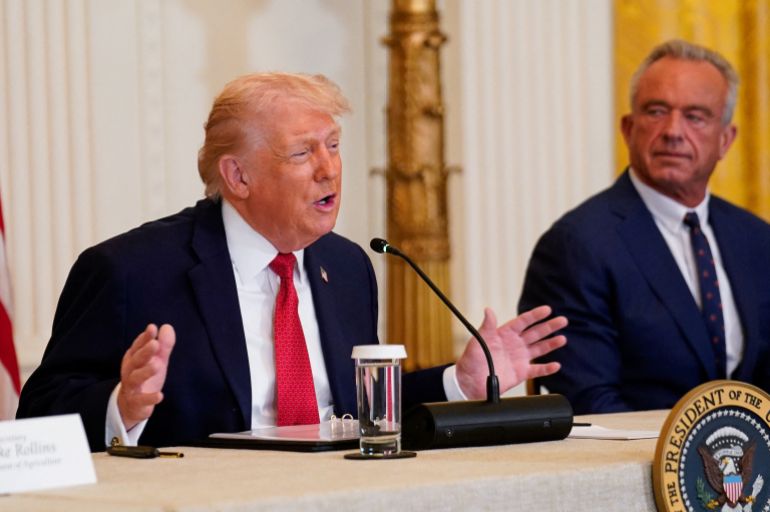 U.S. President Donald Trump and Health and Human Services Secretary Robert F. Kennedy Jr. participate in a roundtable on rural health, at the White House in Washington, D.C., U.S., January 16, 2026. REUTERS/Nathan Howard