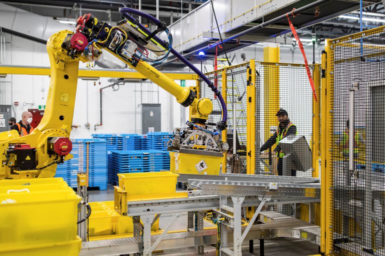 robots-28-01-1769607652 Amazon packages are sorted by a robotic arm during a tour of the advanced robotics facility fulfillment centre, YHM1, in Hamilton, Ontario, Canada April 19, 2022. REUTERS/Nick Iwanyshyn
