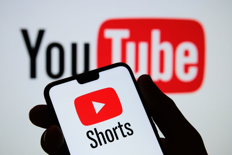 Stafford / UK - September 14 2020: Youtube Shorts app logo seen on the silhouette of smartphone in a hand. It is a new short looping video platform. Real photo, no edit in post.