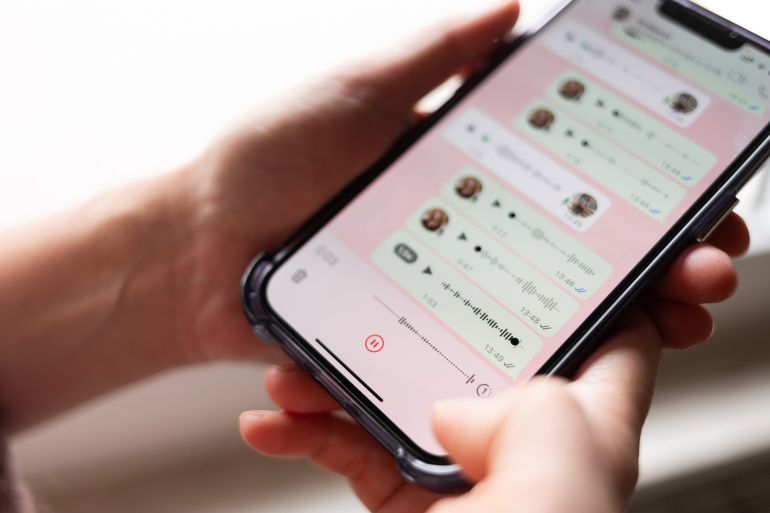 Melle, Germany - October 23, 2025: Female holds smartphone displaying WhatsApp voice messages, with copy space available for text or graphics; Shutterstock ID 2705983411; purchase_order: aj; job: ; client: ; other: