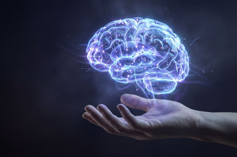 A glowing, digital representation of a human brain rests in the palm of a hand. The futuristic artwork represents intelligence, technology, and the power of the human mind.; Shutterstock ID 2708176663; purchase_order: ajnet; job: ; client: ; other: