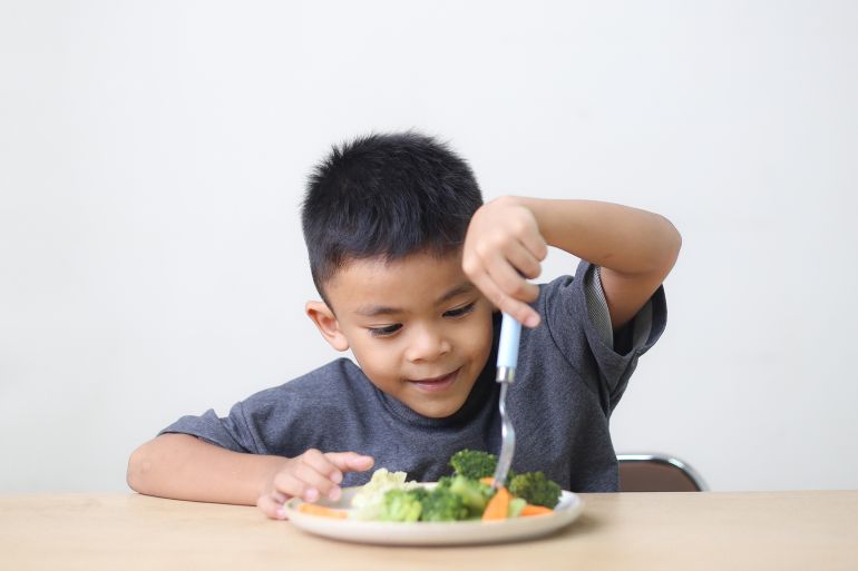 Nutrition healthy eating habits for kids concept. Children do not like to eat vegetables. Little cute boy refuses to eat healthy vegetables.