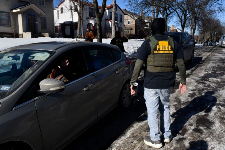 afp_697cfaf32a00-1769798387 Immigration and Customs Enforcement (ICE) agents confront observers monitoring their activity from inside their cars while patrolling a neighborhood in Minneapolis, Minnesota, on January 29, 2026.