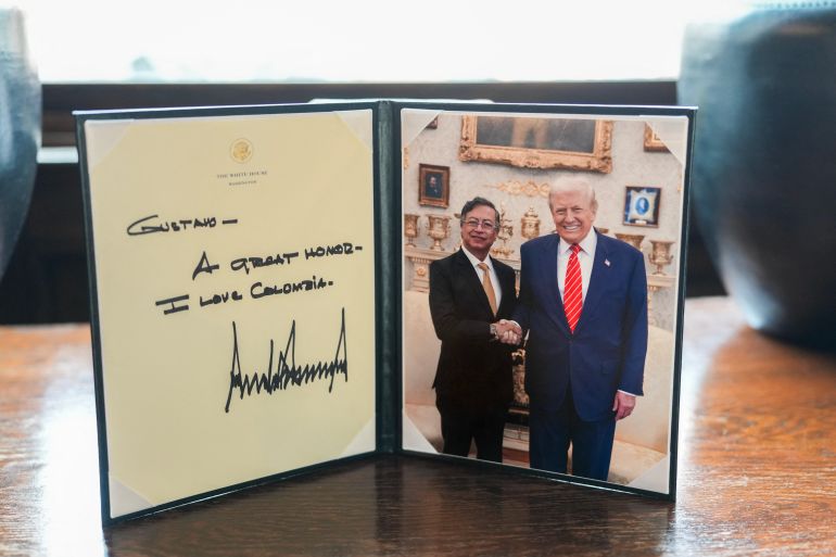 This handout picture released by the Colombian Presidency press office shows a book with an image of Colombian President Gustavo Petro shaking hands with US President Donald Trump at the White House in Washington on February 3, 2026.