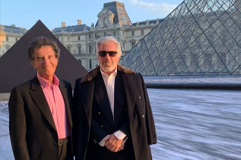 TOPSHOT - A screengrab taken on February 3, 2026 from a video released in files related to the investigation into the late convicted sex offender Jeffrey Epstein, published by the US Department of Justice, shows Jack Lang, a French former culture minister posing with Jeffrey Epstein at the Louvre pyramid in Paris.