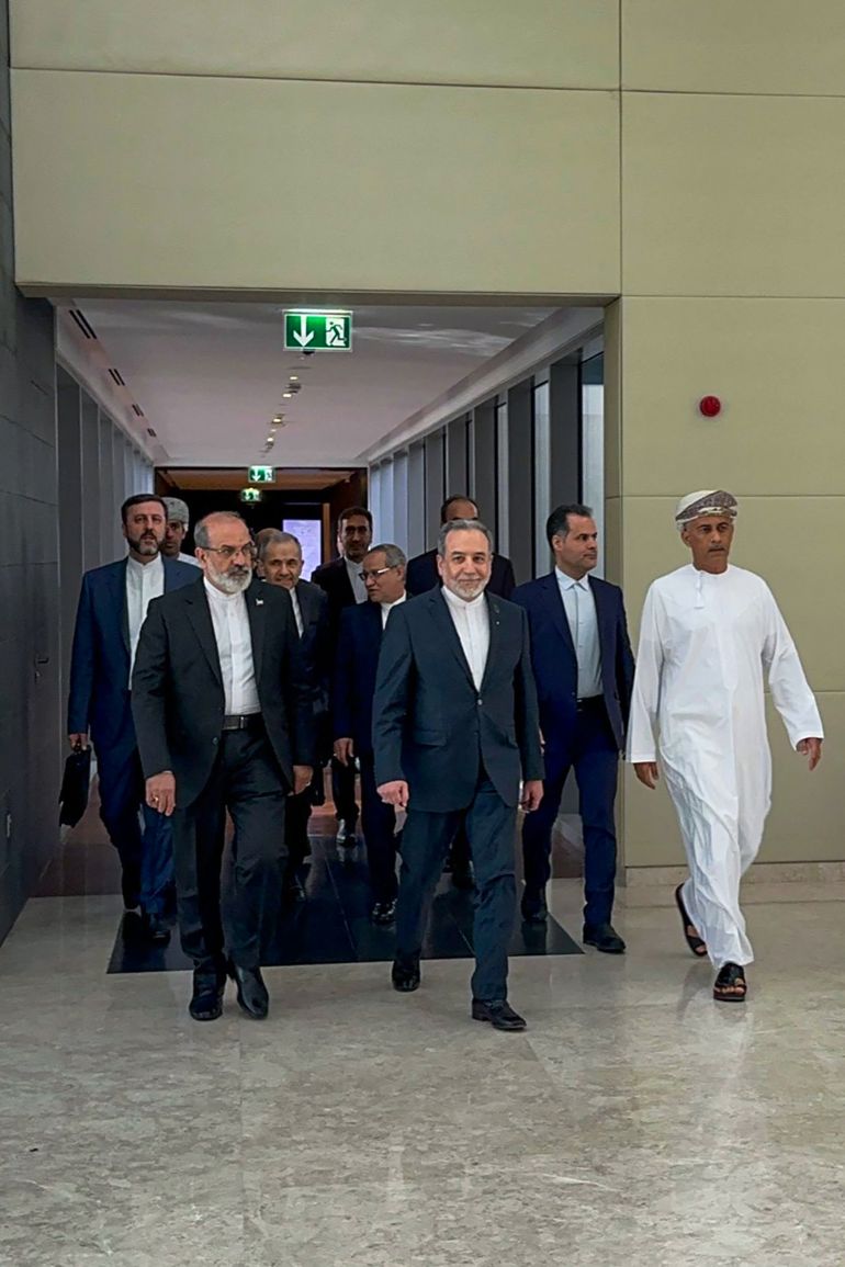 In this handout photo obtained from Iran’s foreign ministry delegation on February 6, 2026, Iran’s Foreign Minister Abbas Araghchi (C) arrives for a meeting in Muscat.