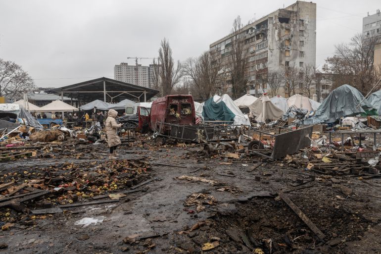 People walk among debris of a local market close to damaged residential building at the site of a Russian attack in Odesa on February 12, 2026, amid the Russian invasion of Ukraine. (Photo by Oleksandr GIMANOV / AFP)