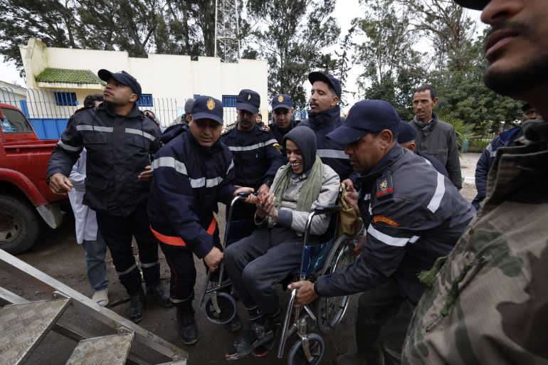 Members of the Royal Armed Forces (FAR), Civil Protection Services and local authorities assist in evacuating people affected by the flooding in the Sidi Slimane region, in northwestern Morocco on February 13, 2026.