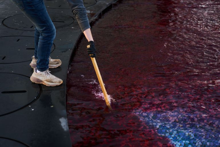 ap26041303248490-1770722279 A supporter of Palestinian citizens of Israel pours red dye symbolizing blood into an ornamental pool during a protest calling for greater security amid rising crime in their communities, in Tel Aviv, Israel, Tuesday, Feb. 10, 2026. (AP Photo/Ariel Schalit)