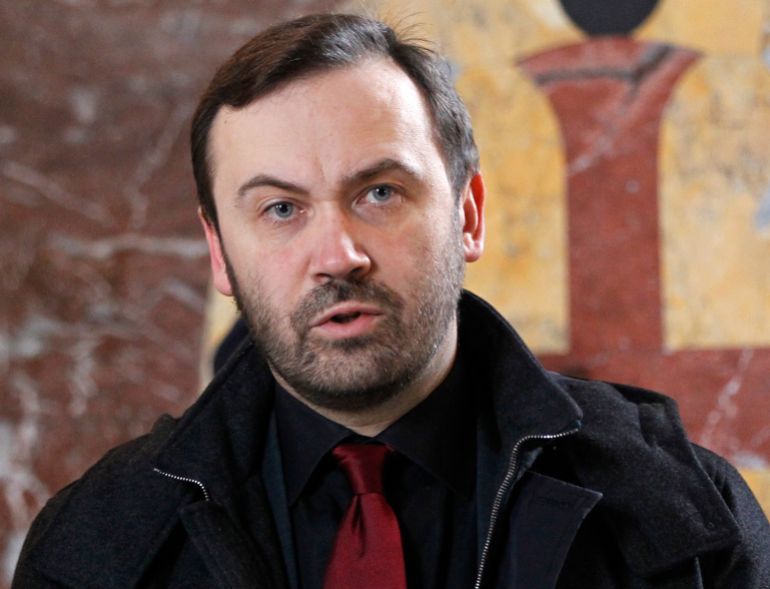Ilya Ponomarev, a fugitive Russian lawmaker, attends a funeral service for slain former Russian lawmaker Denis Voronenkov, at St. Volodymyr Cathedral in Kiev, Ukraine, Saturday, March 25, 2017. A Ukrainian official said Friday that the killer of Voronenkov, who was gunned down in the Ukrainian capital of Kiev, was a Russian agent, a claim quickly rejected by the Kremlin. (e to Ukraine, was shot dead near the entrance of an upscale hotel in the center of the Ukrainian capital on Thursday. He was wanted on criminal charges in Russia. (AP Photo/Sergei Chuzavkov)