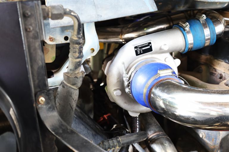 Turbocharged car engine. booster or round silver metal air compressor with air intake system mounted on diesel engine with copy space. Selective focus; Shutterstock ID 2179846611; purchase_order: د; job: ; client: ; other: