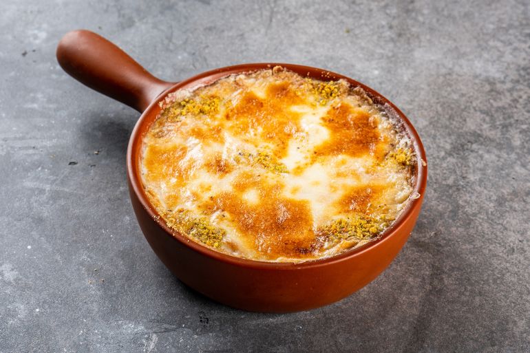 ummali served in pan isolated on dark background side view