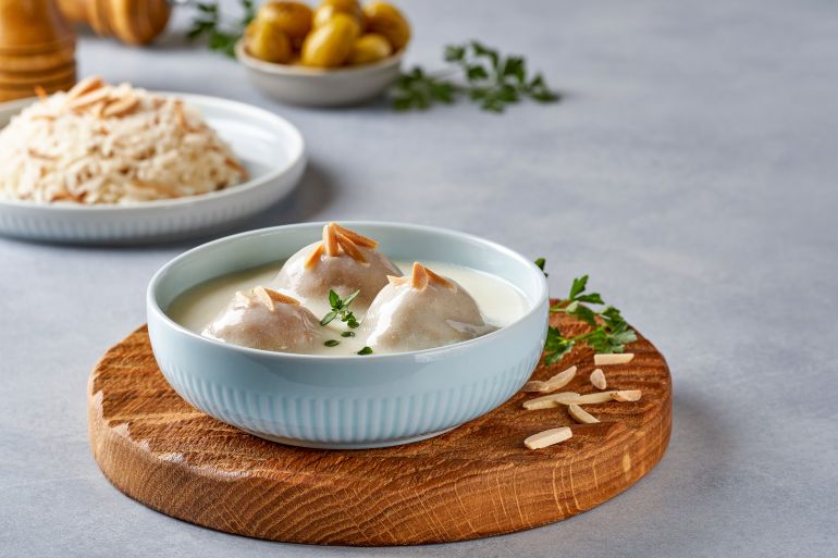 Middle Eastern dish Kibbeh Labanieh . Ground meat with bulgur wheat and yogurt sauce .