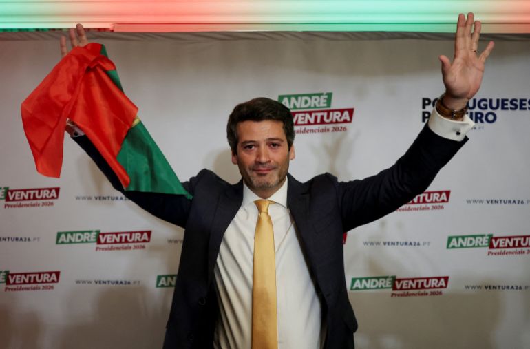 Portuguese presidential candidate and Chega party leader Andre Ventura holds a Portuguese flag after exit polls and early results showed he and Socialist Party candidate Antonio Jose Seguro will head to a runoff next month, in Lisbon, Portugal, January 18, 2026. REUTERS/Pedro Nunes