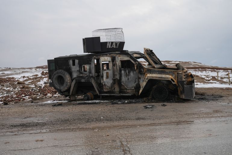epa_6980e407030d-1770054663 epa12675433 Destroyed vehicles on the side of the road as eements of the Syrian army deploy near the front lines with the Syrian Democratic Forces (SDF) 9 kilometres from the city of Al-Hasakah in northeastern Syria, 23 January 2026. EPA/AHMAD FALLAHA