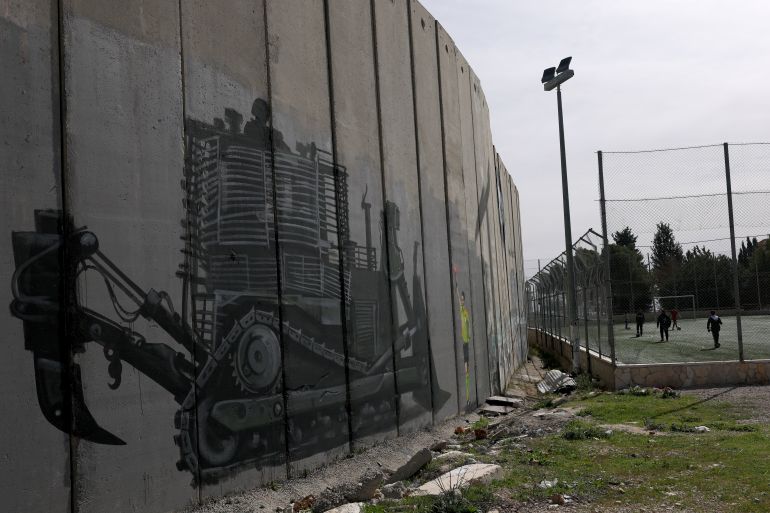 epa12733900 A graffiti painted on the separation wall, at Aida refugee camp youth center pitch in the West Bank city of Bethlehem, 13 February 2026. Local Palestinian artist Taqi Sbetin, has created a graffiti on the separation wall in protest against the Israeli military order issued for the demolition of the playground in the youth center. EPA/ATEF SAFADI