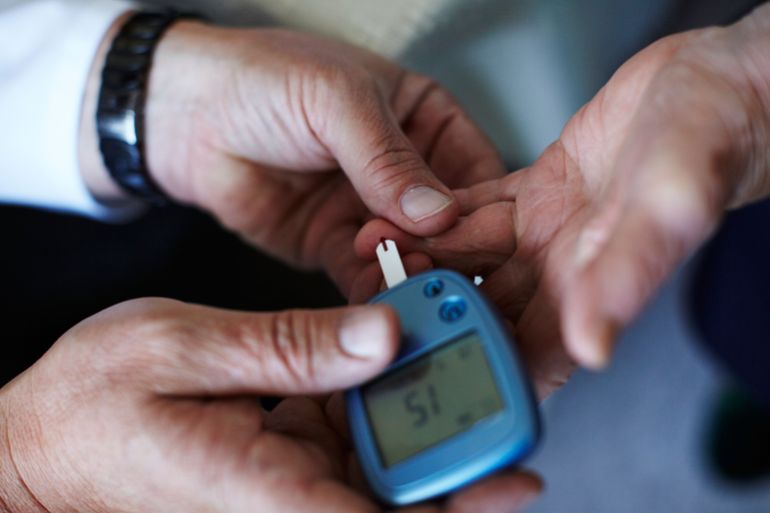 SEELOW, BRANDENBURG - AUGUST 08: Country doctor Dieter Baermann measures the blood sugar level of an elderly patient in the patient's home on August 8, 2011 in Sachsendorf near Seelow, Germany. Baermann works in the state of Brandenburg in eastern Germany, a region that is struggling with a shortage of doctors in rural areas. Critics charge that current laws actually discourage doctors from taking up posts in rural areas, and the German government is debating a new law intended to reverse the trend. Many doctors across Germany complain about a legal system that they claim burdens them with too many costs and hampers their ability to provide the best care. (Photo by Carsten Koall/Getty Images)