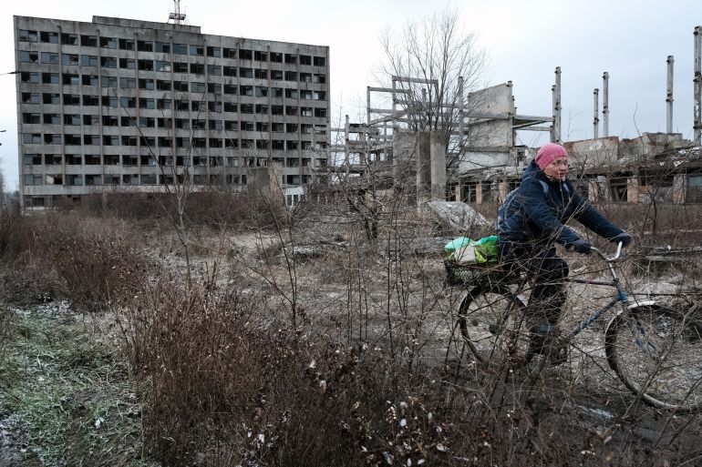 KUPIANSK, UKRAINE - JANUARY 06: People move through the town of Kupiansk which has experienced regular shelling from the Russians on January 06, 2023 in Kupiansk, Ukraine. Despite a unilateral Russian ceasefire ordered by President Vladimir Putin, shelling could be heard throughout the day. Kupiansk was occupied by Russian forces mere days after their February 24th invasion of Ukraine, a process hastened by the surrender of Kupiansk's Russia-friendly mayor. Ukrainian forces liberated the town in September, but Russia turned its artillery on Kupiansk while in retreat, destroying buildings and damaging energy and heating infrastructure. Another Russian missile strike occurred here at the end of the year. (Photo by Spencer Platt/Getty Images)